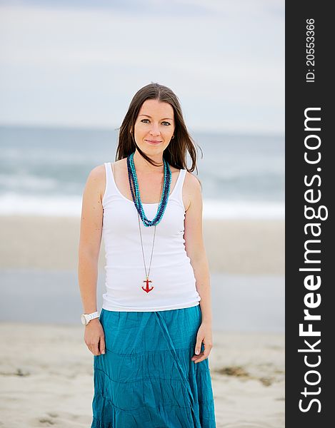 Beautiful Young Woman Stands Against Ocean