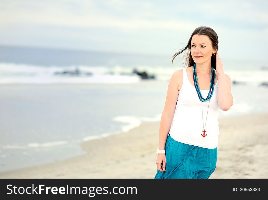 Beautiful Young Woman Stands Against Ocean