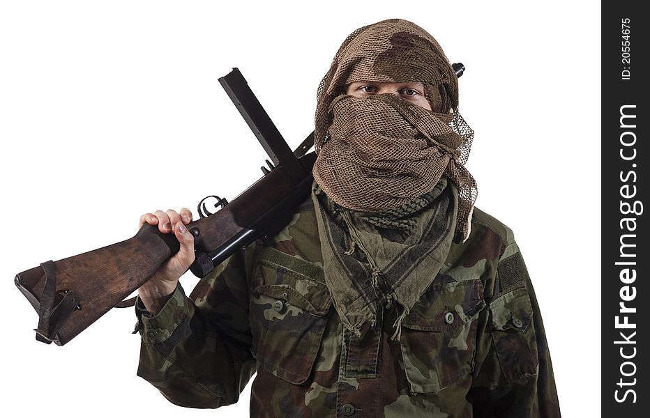 Camouflaged guerrilla soldier with hidden face and a machine gun. Isolated on white background. Camouflaged guerrilla soldier with hidden face and a machine gun. Isolated on white background.