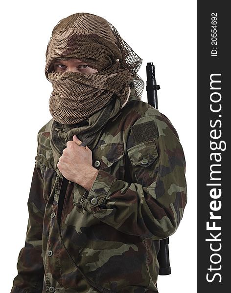 Camouflaged guerrilla soldier with hidden face and a machine gun. Isolated on white background. Camouflaged guerrilla soldier with hidden face and a machine gun. Isolated on white background.