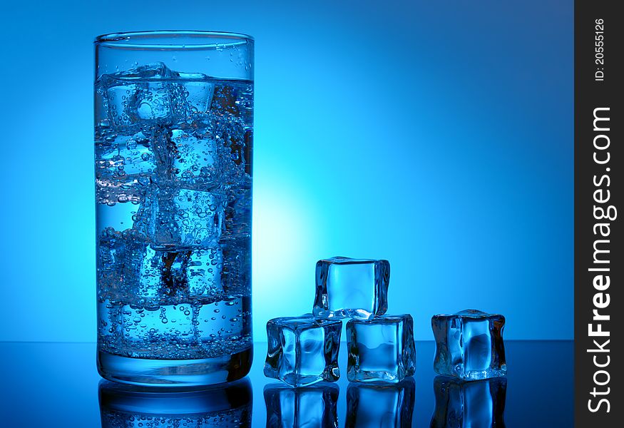 Ice cubes and cold water in glass