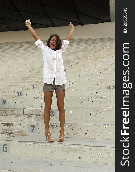 Beautiful Girl Jumping In An Empty Stadium