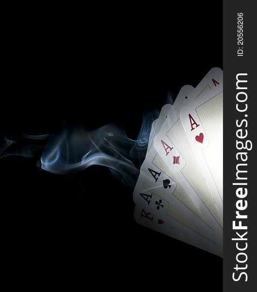 Four aces with smoke with dark background