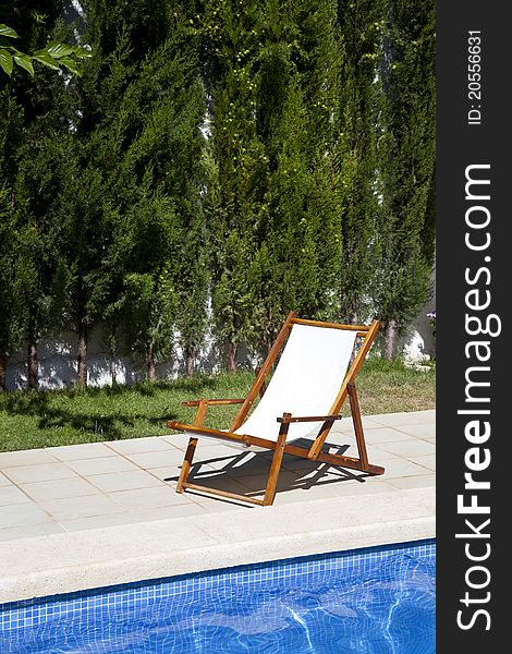 Deckchair in a swimming pool on a summer day