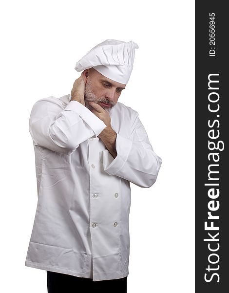 Portrait of a chef in a chef's hat and uniform looking down and thinking isolated on a white background.