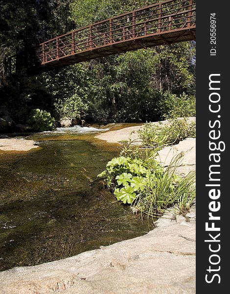 Small bridge over gently running stream. Small bridge over gently running stream