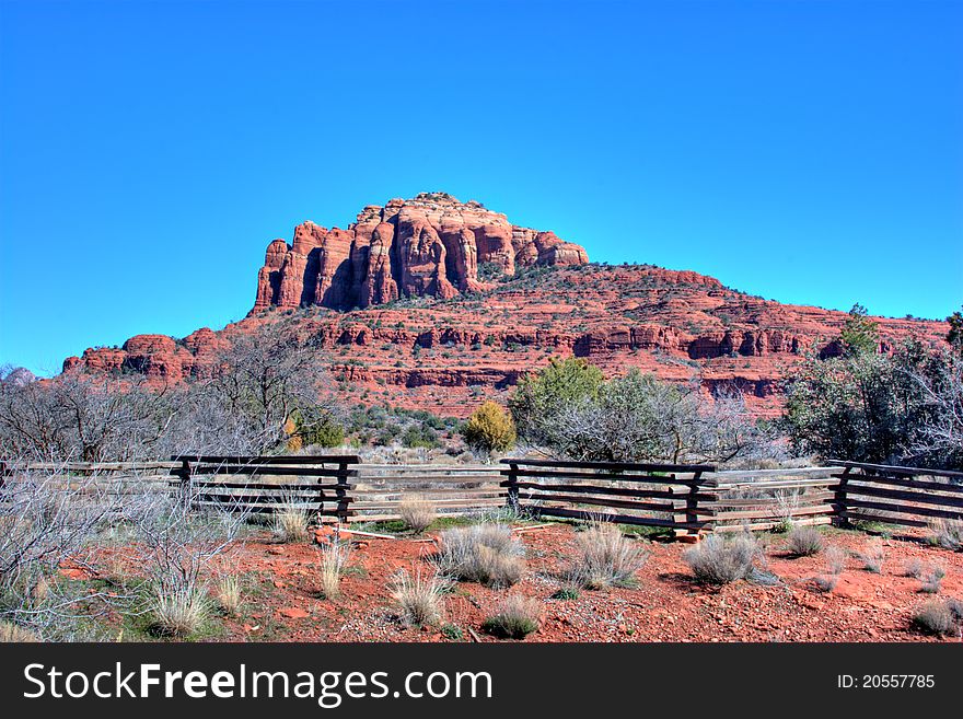 A wooden fence borders private property at the base of a red rock mountain in Sedona, Arzona. A wooden fence borders private property at the base of a red rock mountain in Sedona, Arzona.