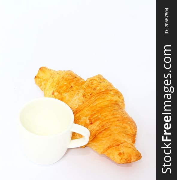 French croissant with empty coffee cup. French croissant with empty coffee cup