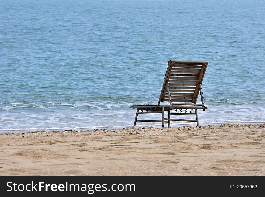 A rest chair on sand beach of sea, shown as spending holidy at sea beach or lonely and calmly stay. A rest chair on sand beach of sea, shown as spending holidy at sea beach or lonely and calmly stay.