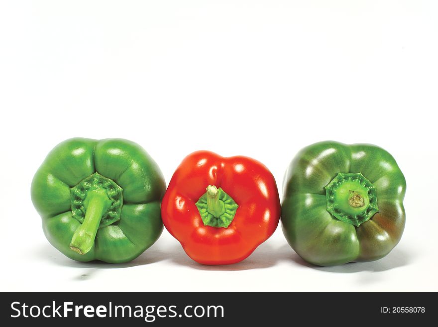 Fresh green and red pepper isolated on white. Fresh green and red pepper isolated on white