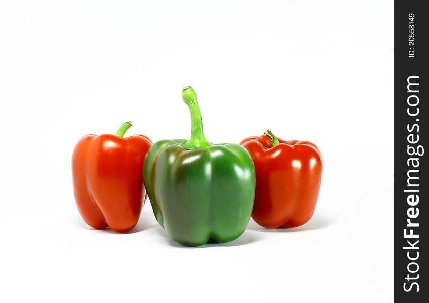 Fresh green and red pepper on white background. Fresh green and red pepper on white background