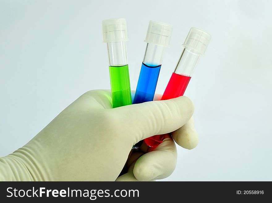 A medical technician holding a test tubes of reagent