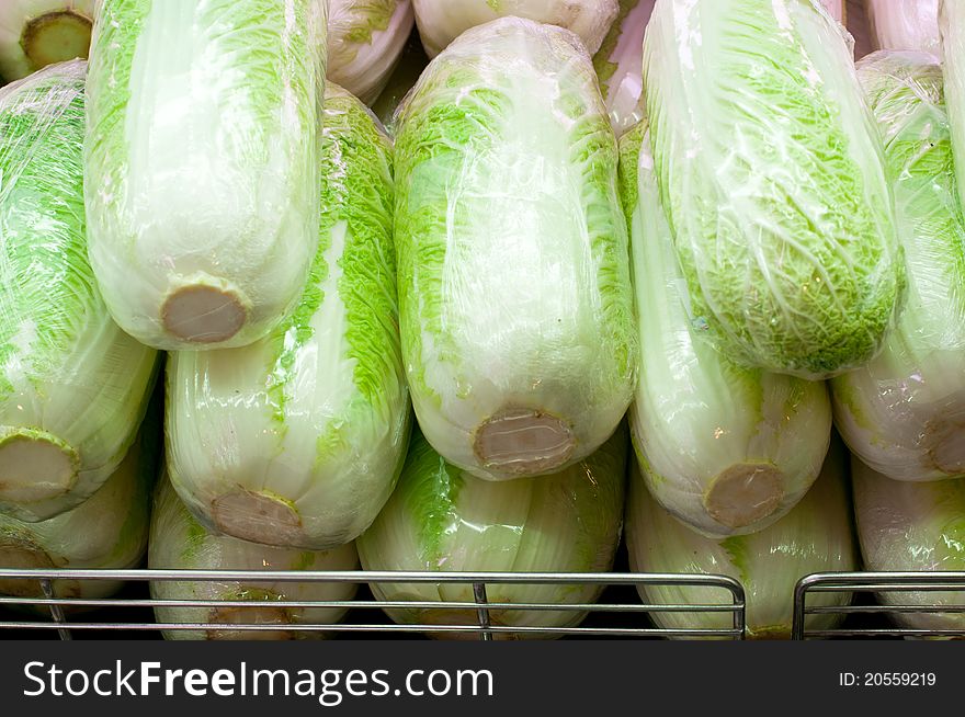 Stack of plastic wrapped Chinese cabbage