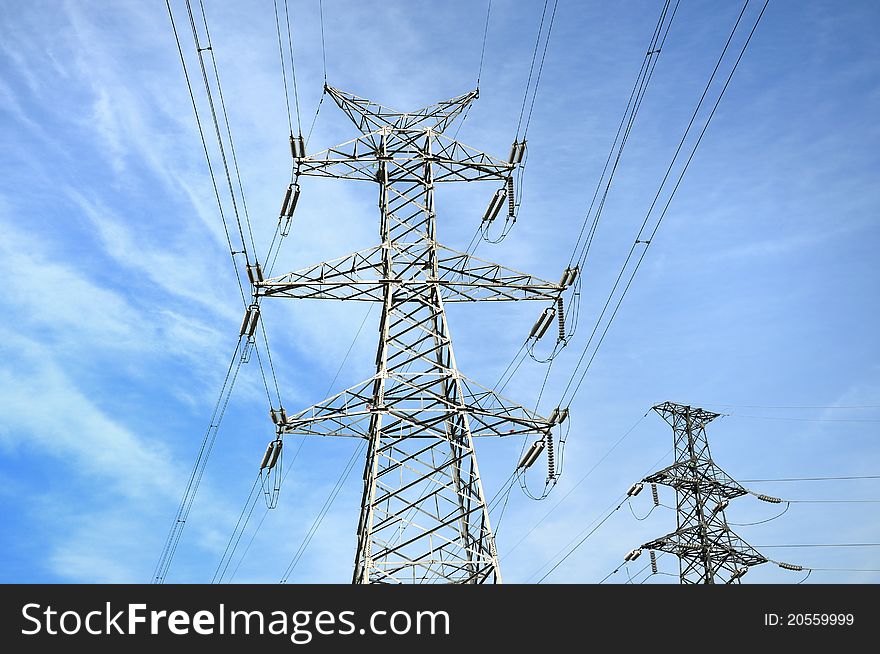 High-tension line and transformer over white cloud.