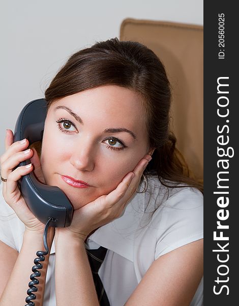 Businesswoman listening to on the phone at the office. Businesswoman listening to on the phone at the office