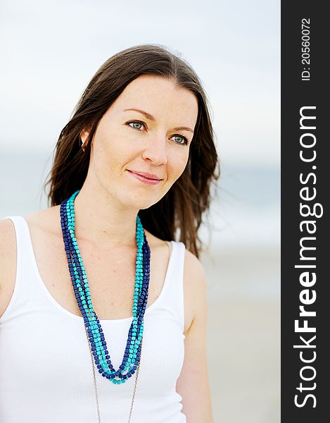 Portrait of a beautiful brunette woman with a necklace. Portrait of a beautiful brunette woman with a necklace