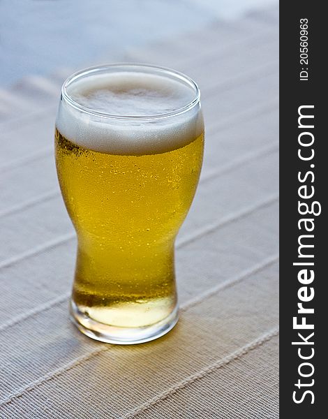 Glass full of beer on table. Glass full of beer on table