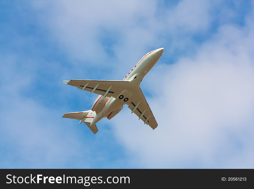 A business jet after take off, pictured form below