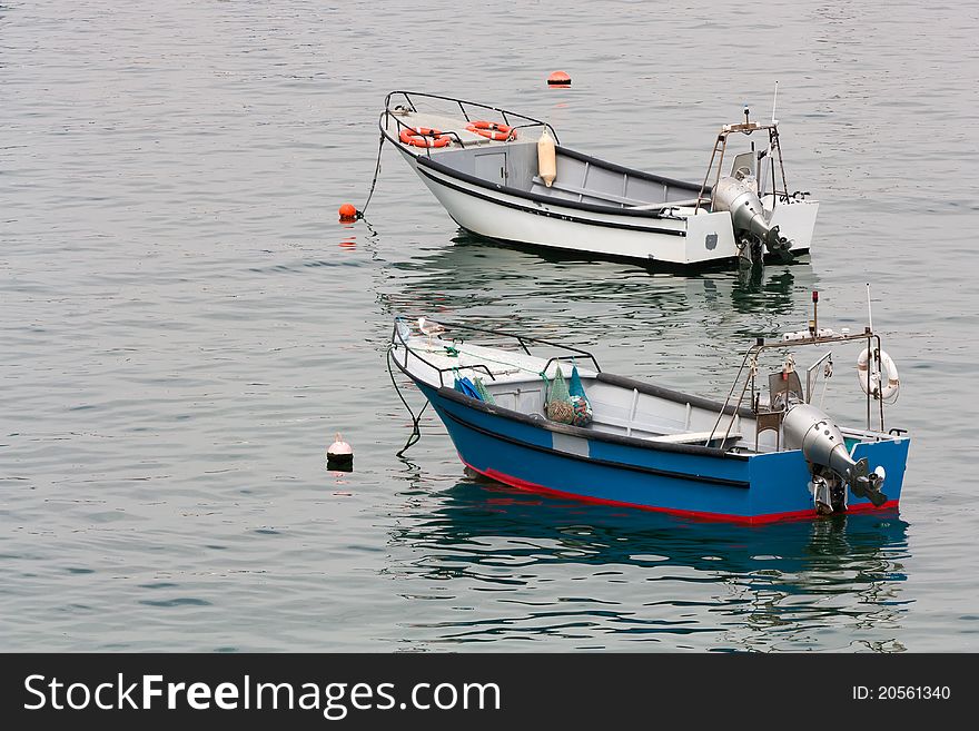 Two fishing boats floating in the ocean in Cascais, Portugal