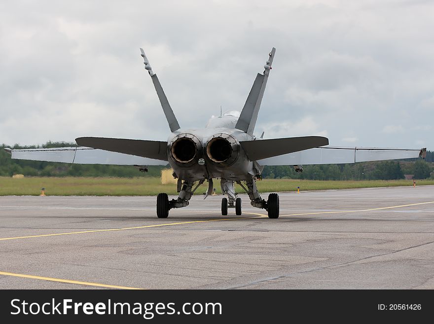 Rear view of a Boeing F/A-18 fighter jet taxiing for take off. Rear view of a Boeing F/A-18 fighter jet taxiing for take off