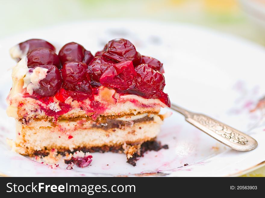 Piece of berry pie on saucer and spoon