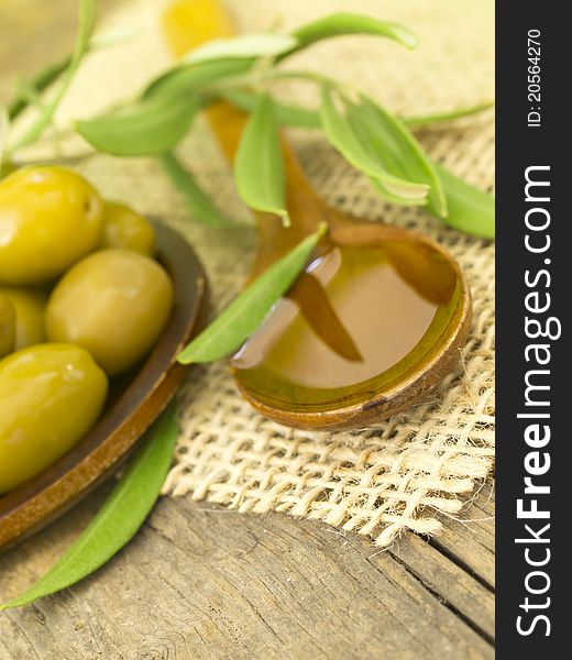 In the spoon with fresh olives on the wooden table. In the spoon with fresh olives on the wooden table