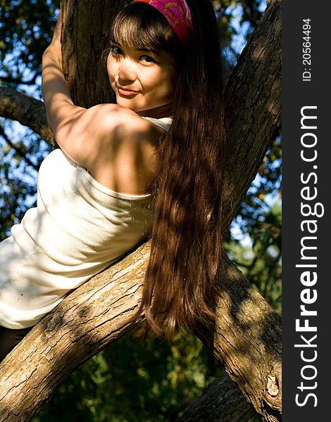 Girl climbing a tree in park