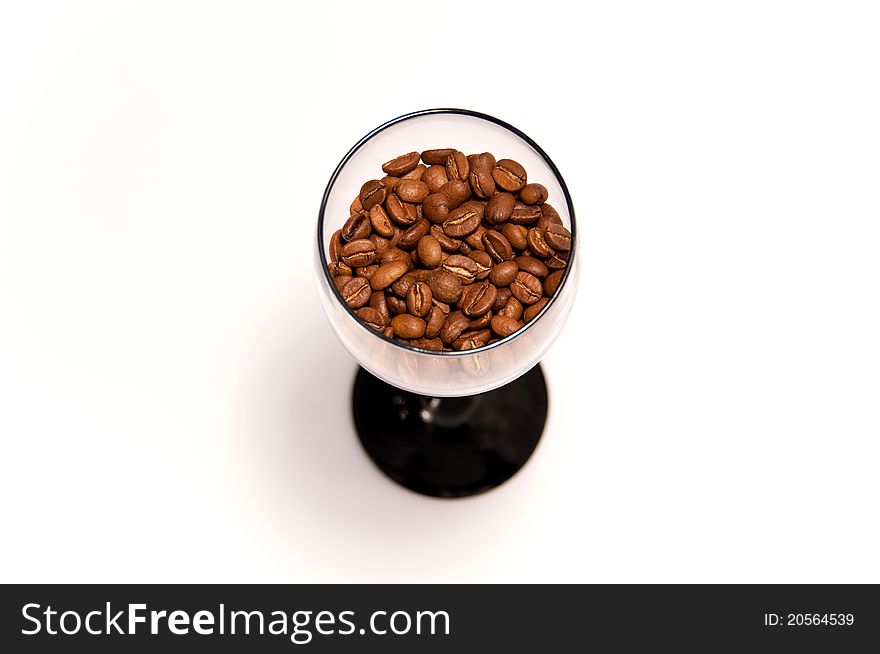 Coffee beans in glass cup on white background