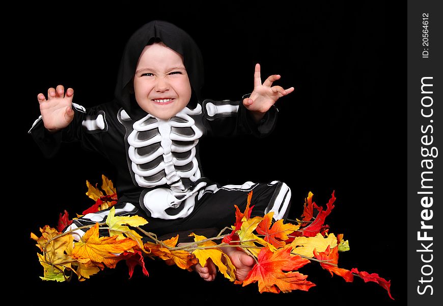 Adorable little boy dressed in scary skeleton costume. isolated on black. Adorable little boy dressed in scary skeleton costume. isolated on black