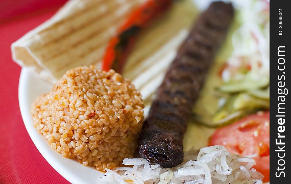 Traditional turkish Adana kebab served with rice, vegetables and lavash. Traditional turkish Adana kebab served with rice, vegetables and lavash