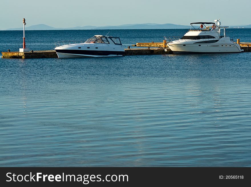 Two yachts in sea at mooring early morning. Two yachts in sea at mooring early morning