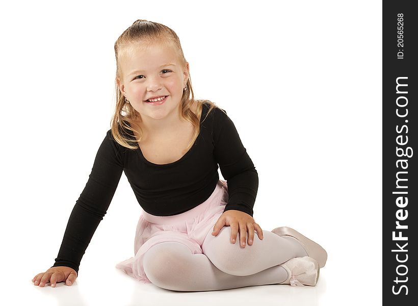 A pretty 3-year-old sitting pretty in her ballerina clothes. Isolated on white. A pretty 3-year-old sitting pretty in her ballerina clothes. Isolated on white.