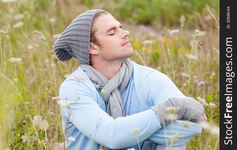 Young man in field relaxing