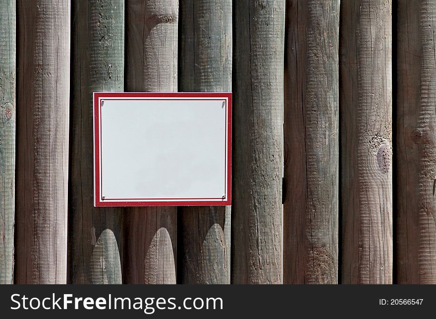 Blank sign on wooden wall.