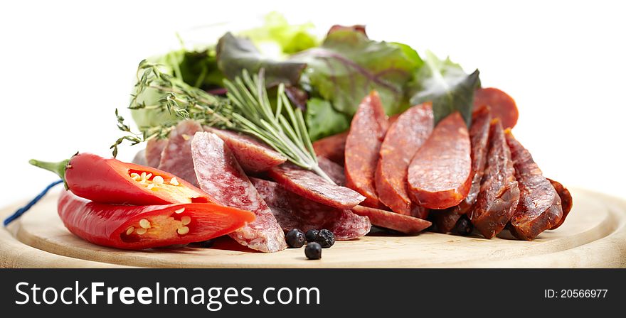 Still life of Spanish traditional sausages Chorizo and Salchichon on white background