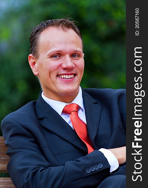 Portrait of happy smiling young businessman