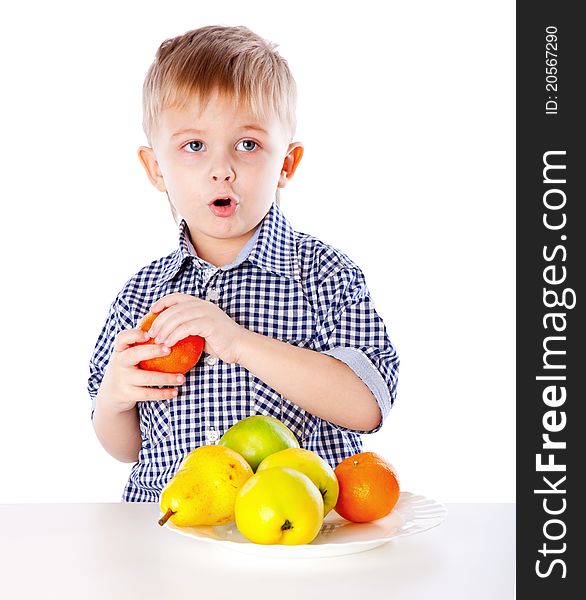 A boy and the plate of  fruits. Isolated on a white background. A boy and the plate of  fruits. Isolated on a white background