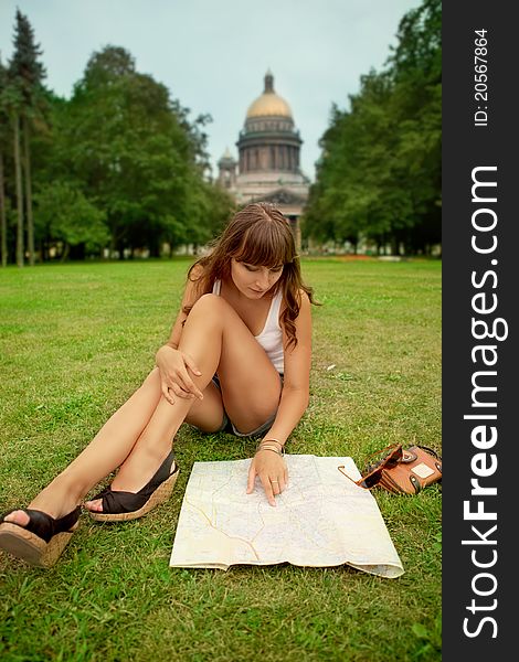 Portrait of happy young tourist girl with the map