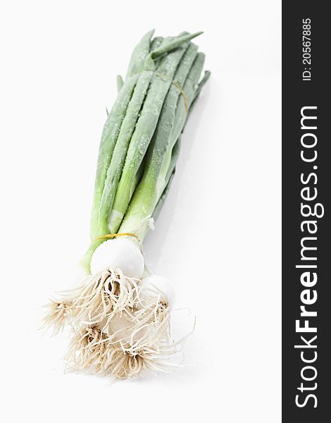 Spring onions on white background