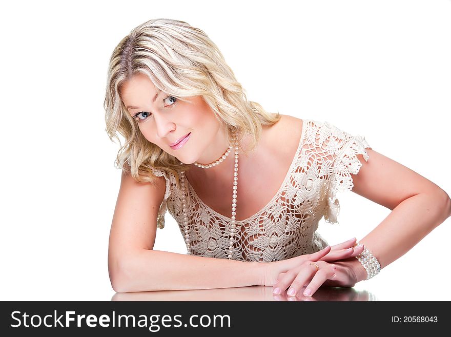 Coquettish blonde woman wearing white knitted lacy
