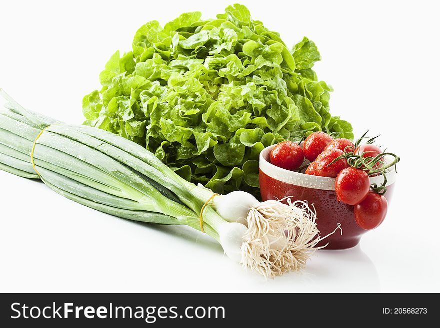 Salad, tomatoes and spring onions on white background. Salad, tomatoes and spring onions on white background