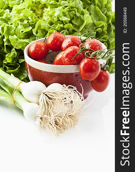 Salad, tomatoes and spring onions on white background. Salad, tomatoes and spring onions on white background