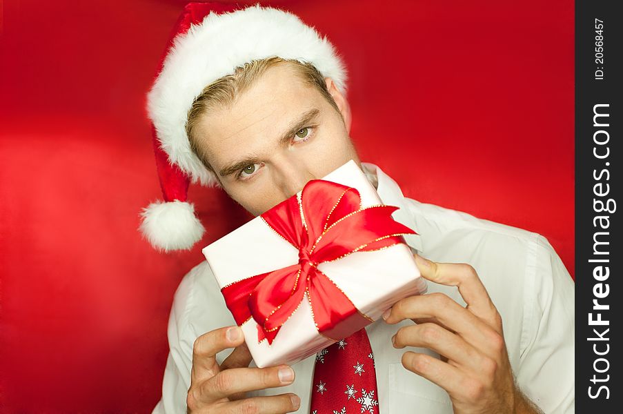 Holding a gift isolated on red. Holding a gift isolated on red