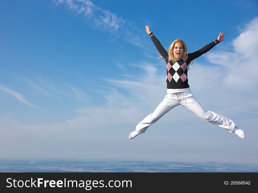 Beautiful blond girl flying in the air, concept of freedom