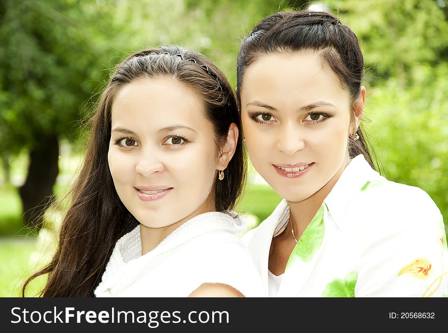 Portrait of two happy young women in a summer garden. Portrait of two happy young women in a summer garden