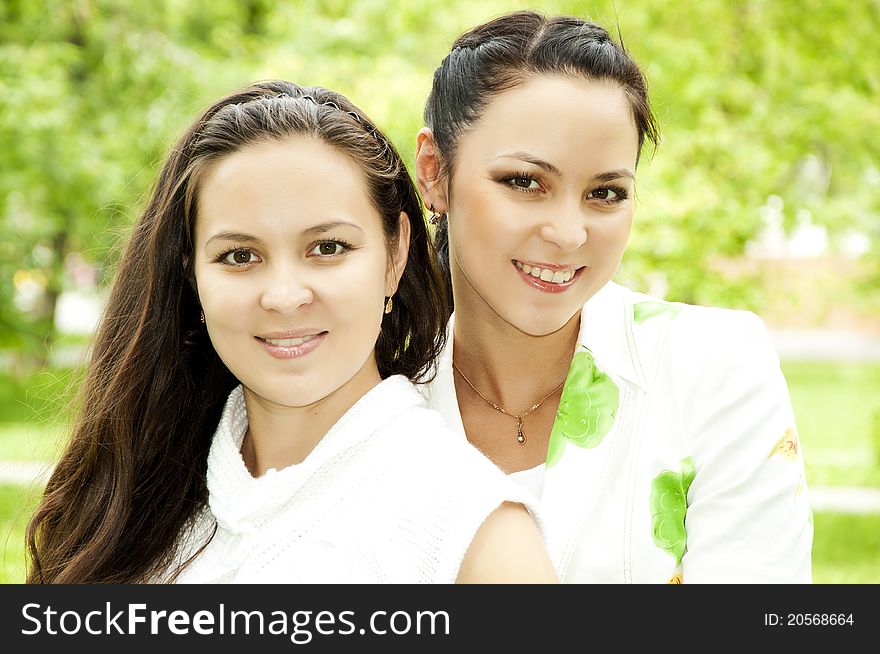 Portrait of two happy young women in a summer garden. Portrait of two happy young women in a summer garden