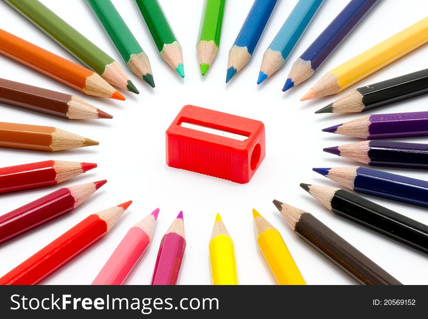 Color pencils and sharpener on white background. Color pencils and sharpener on white background