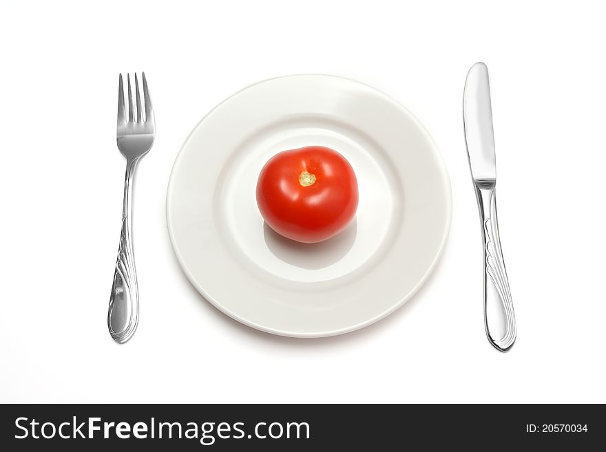 Red tomato on white plate. Red tomato on white plate