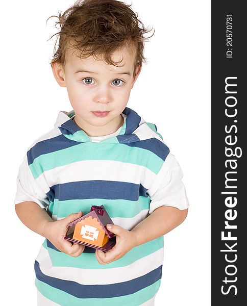 Little boy holding a toy house isolated on white