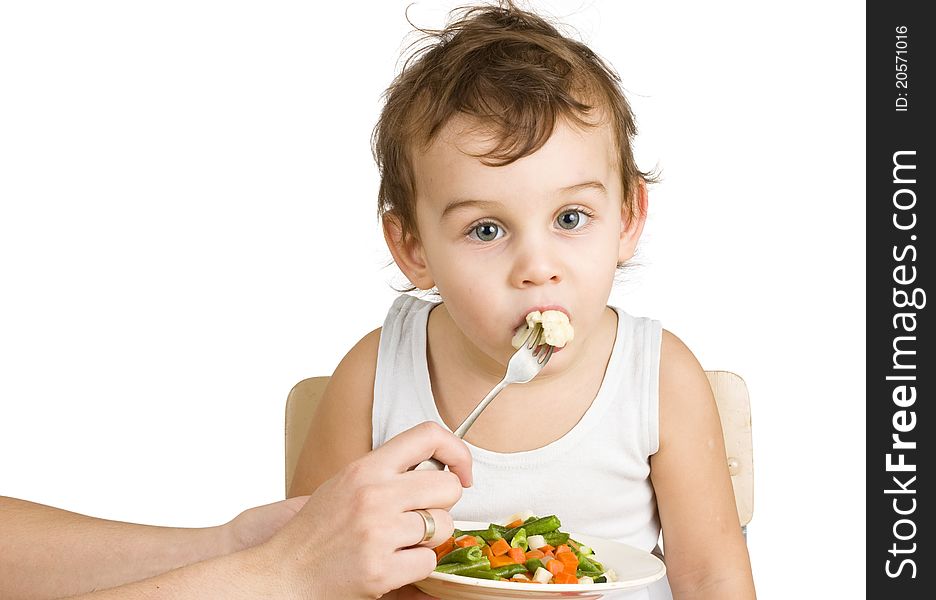 Little boy tasting vegetable salad. Little boy tasting vegetable salad